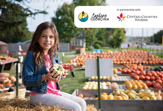 girl holding squash at fall farm in Georgina