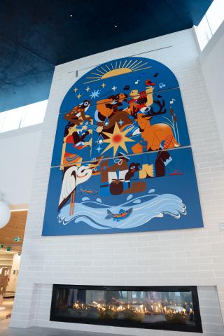 colourful art piece on wall above a fireplace