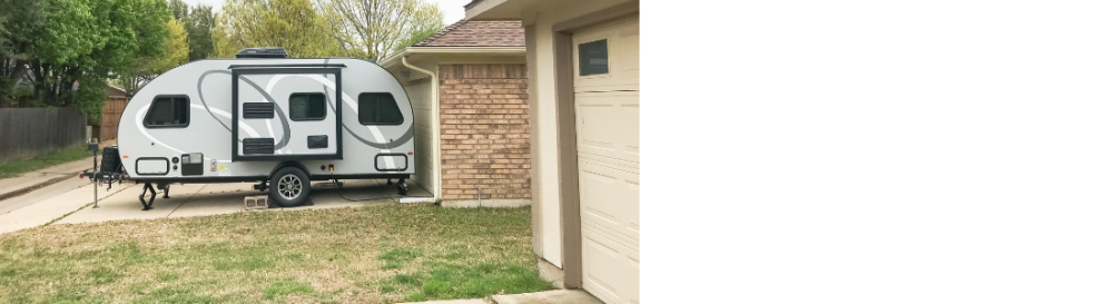 a RV trailer parked on a driveway